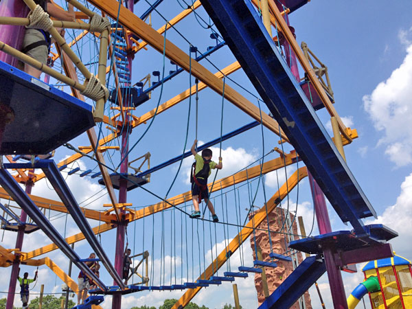 Boy on ropes course.