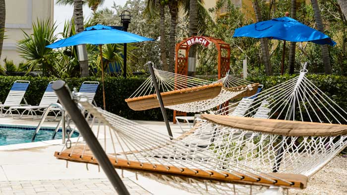Hammocks and a path to the beach at Comfort Suites Seven Mile Beach in Grand Cayman.