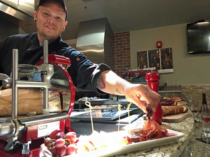 Chef serving proscuitto.