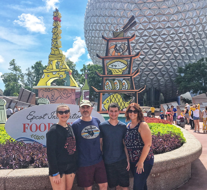 Family of four in front of EPCOT entrance.