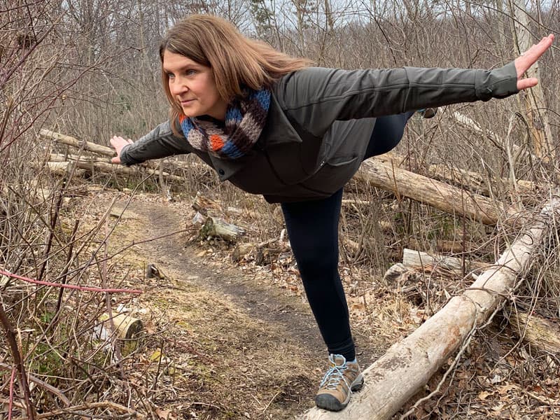 woman balancing on a log