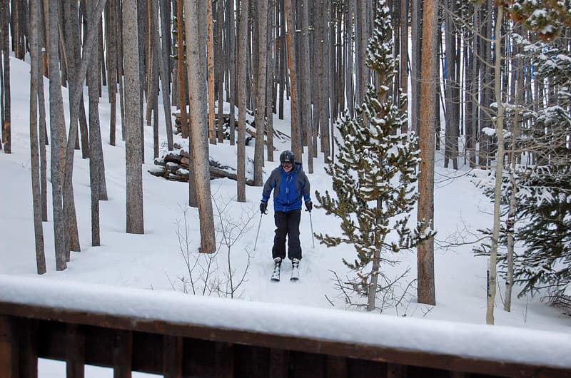 man skiing in to ski house