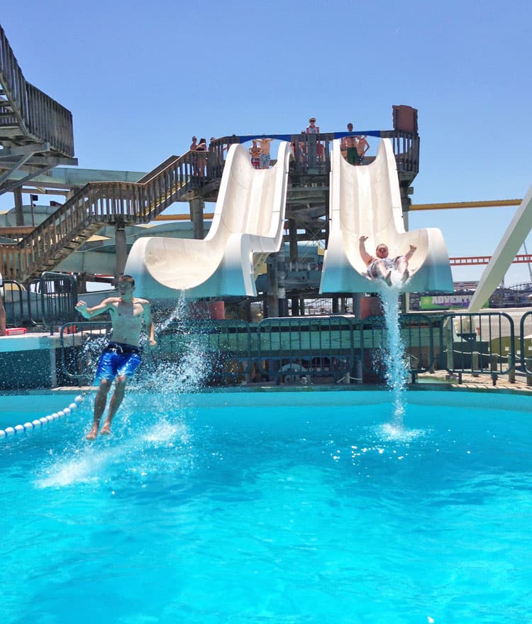 People sliding down water slides.