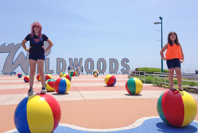 Girls in front of Wildwoods sign.