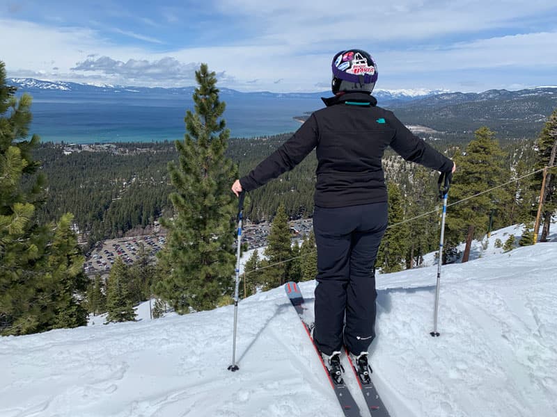 Shannon on skis looking at lake view.