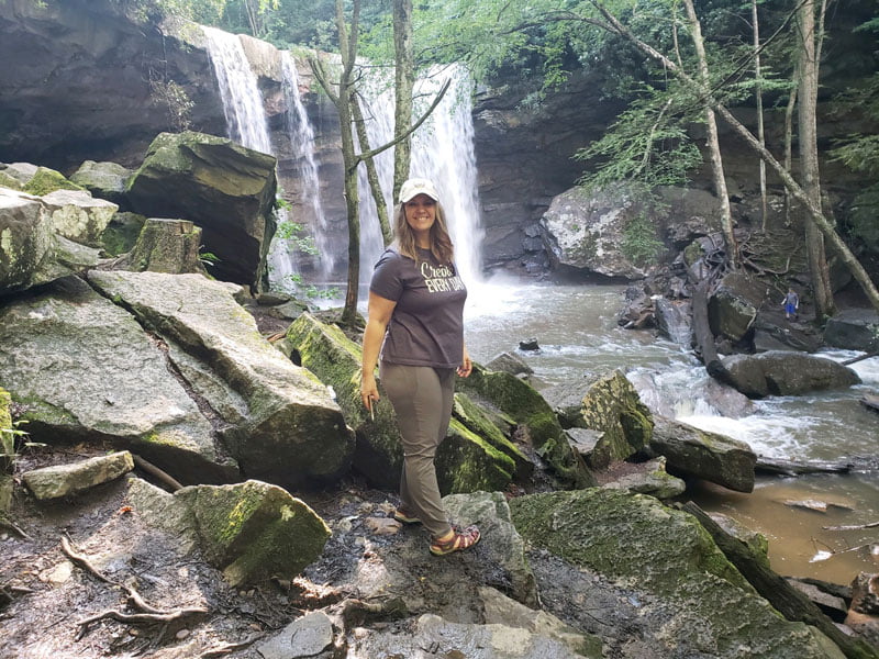 Shannon standing in front of Cucumber Falls.