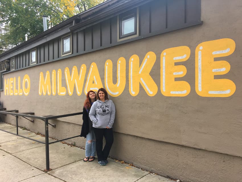 Shannon and her daughter standing in front of "Hello Milwaukee" mural.