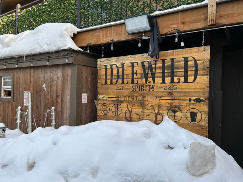 Idlewild restaurant entry sign in front of a snowbank.