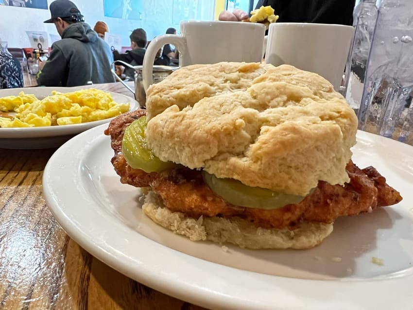 Fried chicken and pickles on a biscuit.