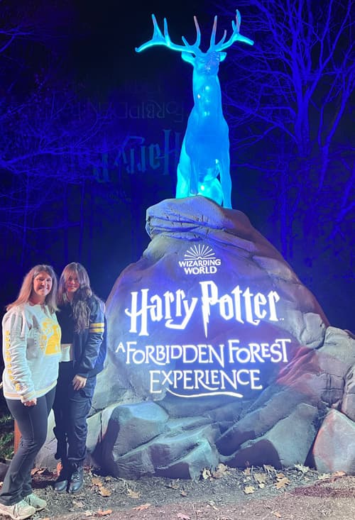 Mother and daughter standing at entrance to Harry Potter Forbidden Forest Experience.